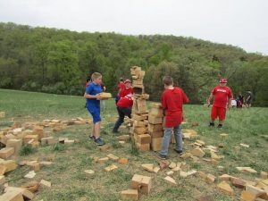 boys stack wood for model cairns