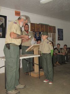 boy stands to receive badges
