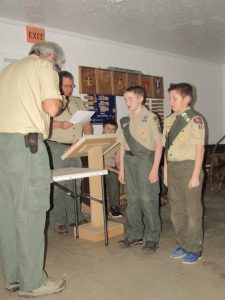 boys stand to receive rank